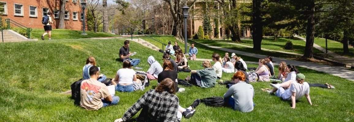 Joe Weiss teaches a class outdoors on a sunny day.